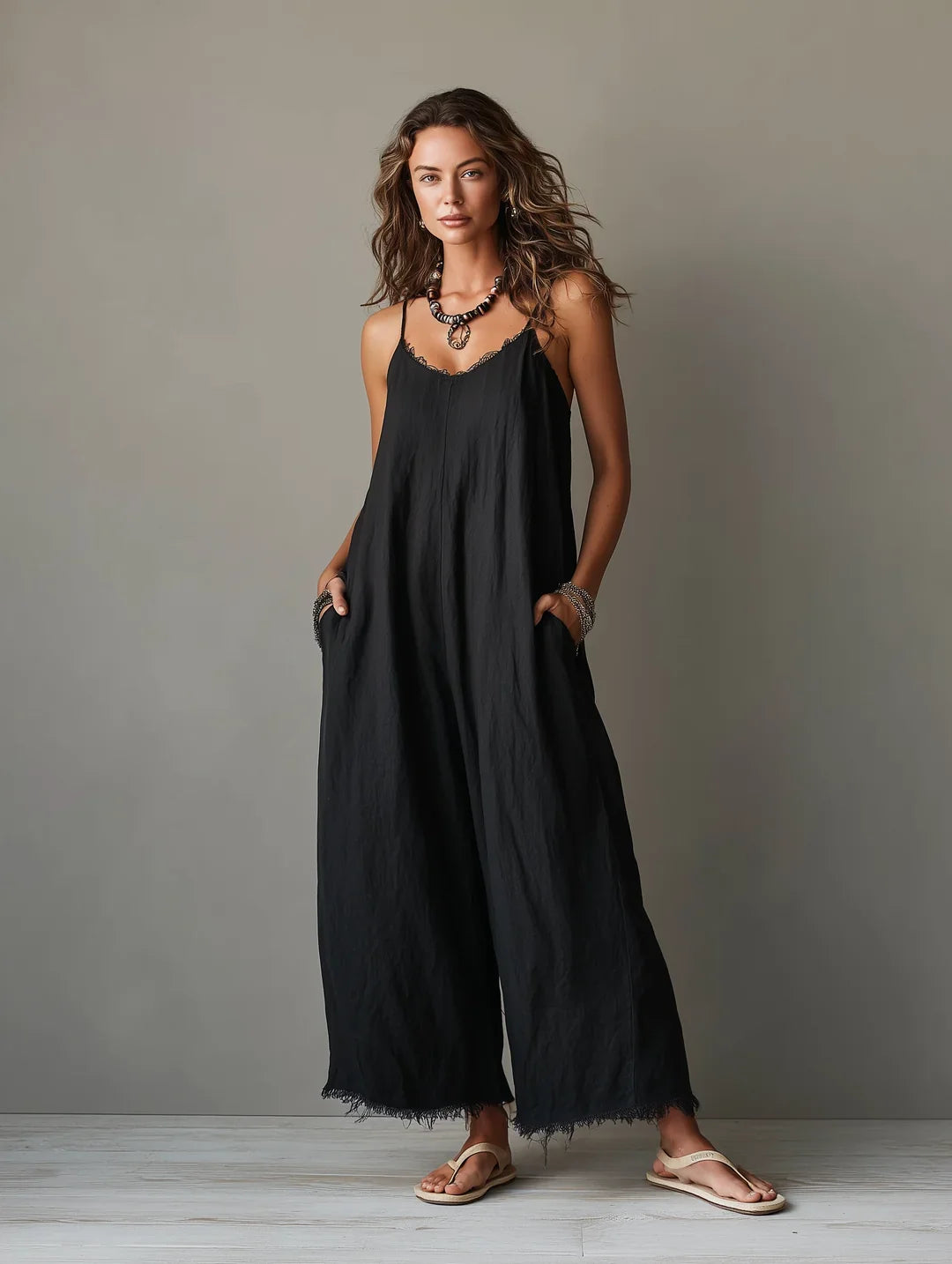 Léa minimalist jumpsuit in black, relaxed full-length side-front view