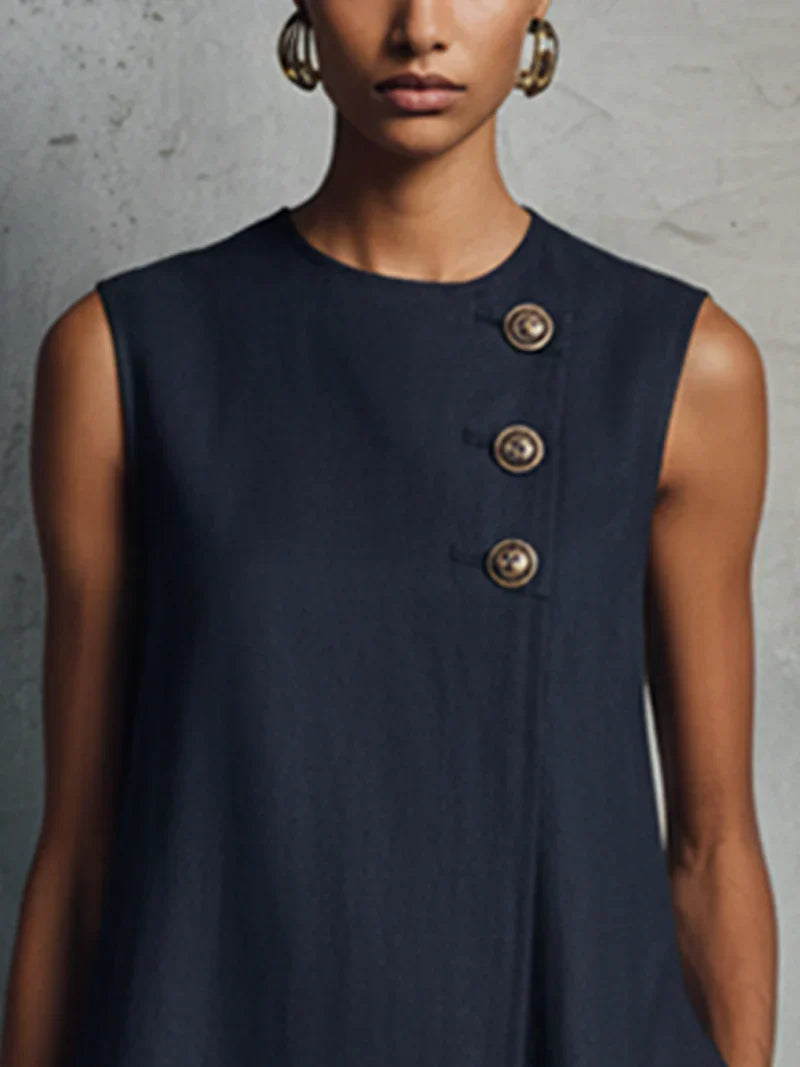 Aubrey mini dress in navy, close-up of asymmetric gold-toned buttons