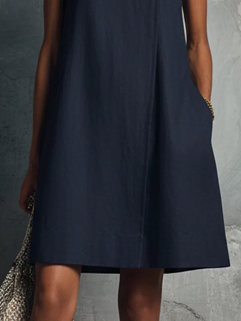 Aubrey navy mini dress, close-up of flared hem and side pocket