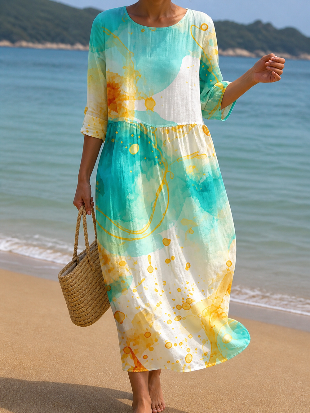 Watercolour print beach dress in turquoise and yellow, full-length front view on the beach