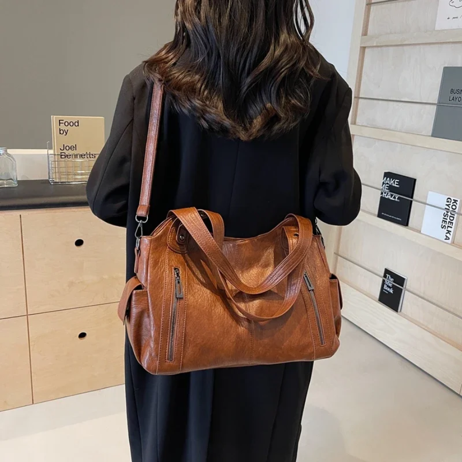 Casual shoulder bag in cognac worn crossbody with long strap