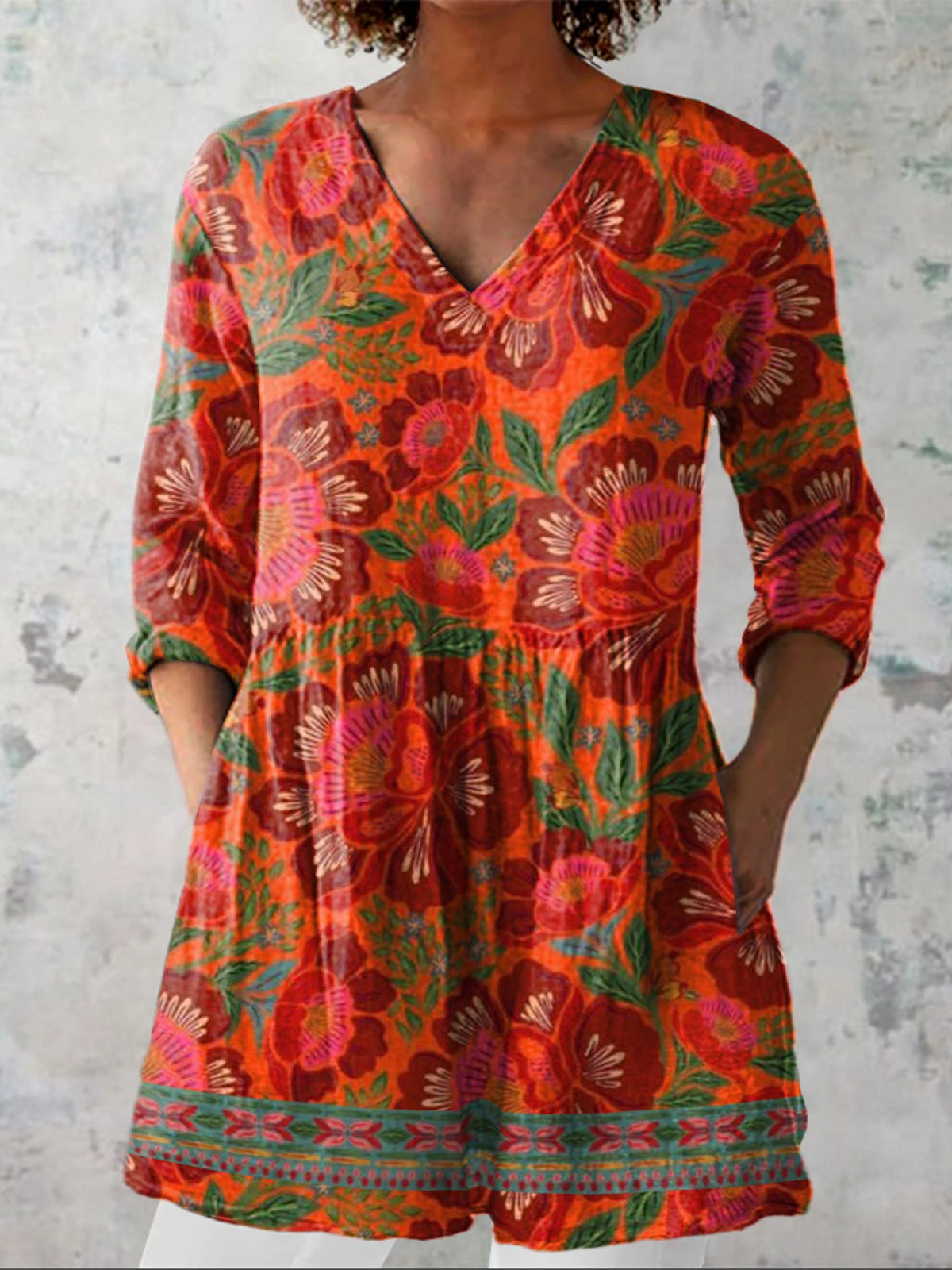 Marion long V-neck blouse in red orange floral print, front view with side pockets