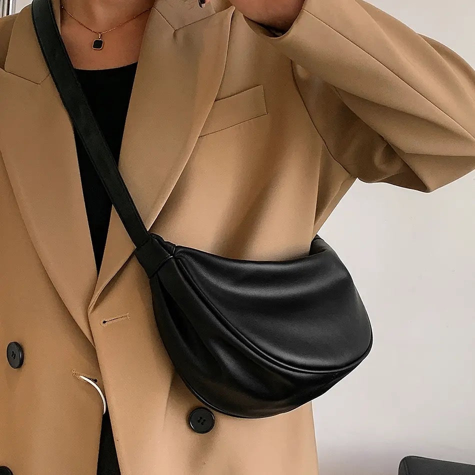 Maribel petite crescent bag in black worn crossbody with a camel blazer