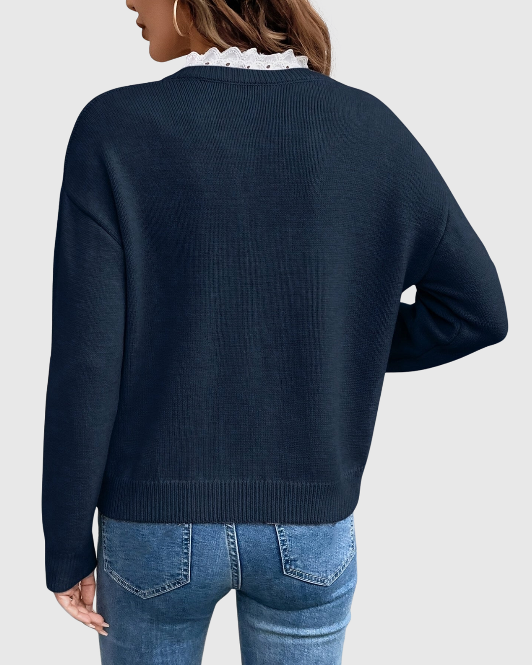 Carenza knitted sweater in navy blue, back view showing ribbed hem