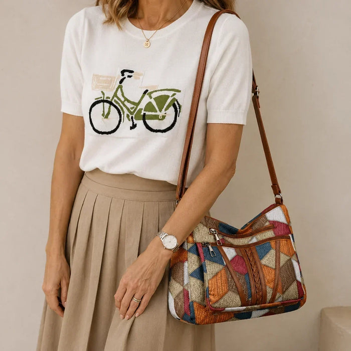 Nella patchwork bag in multicolour, worn on the shoulder with a pleated skirt