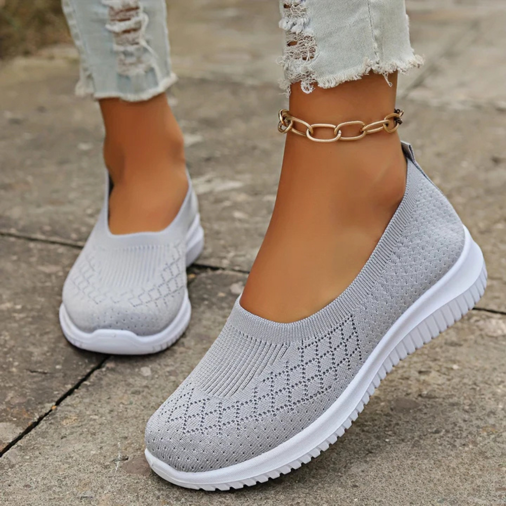 Estella slip-on shoes in grey, worn with jeans, side view