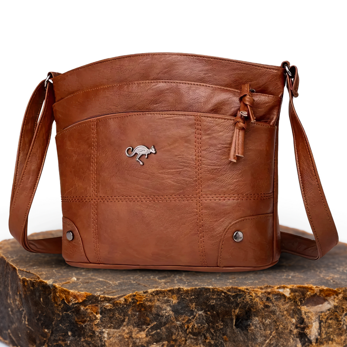 Judith handbag in brown, front view on stone