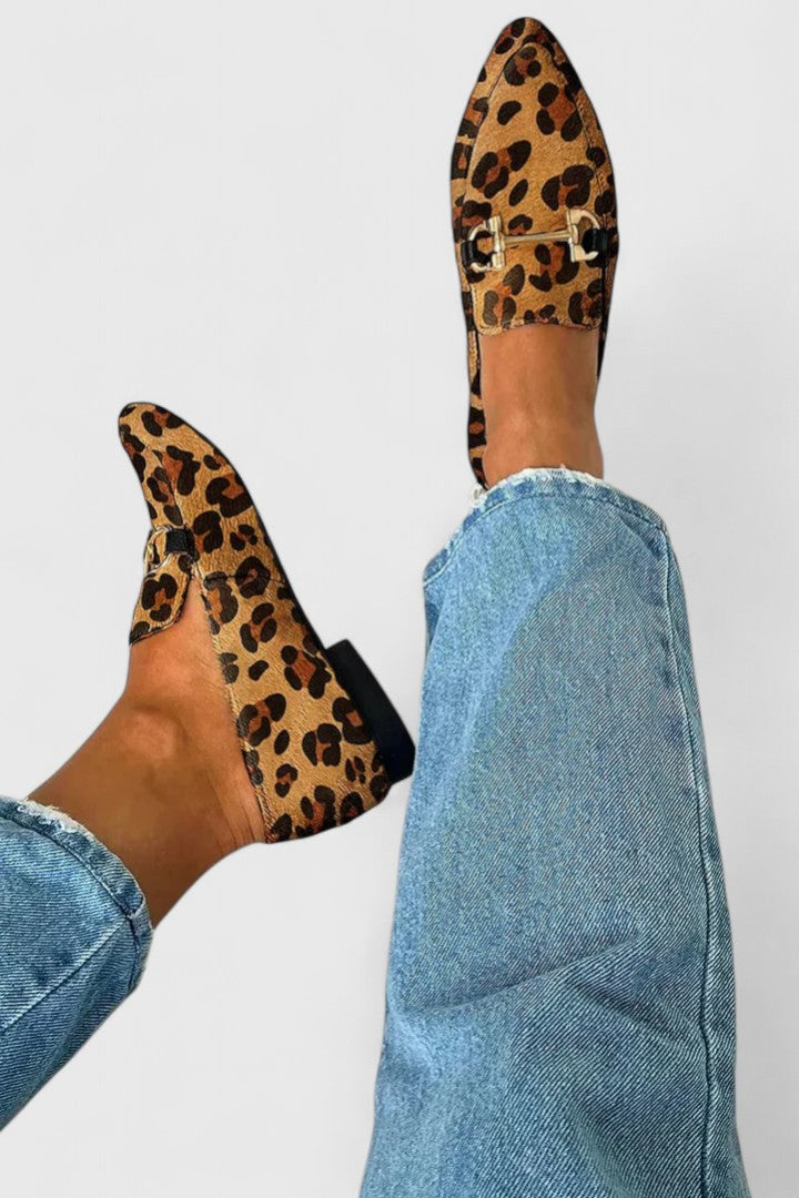 Penelope leopard print loafers worn with blue jeans, side view