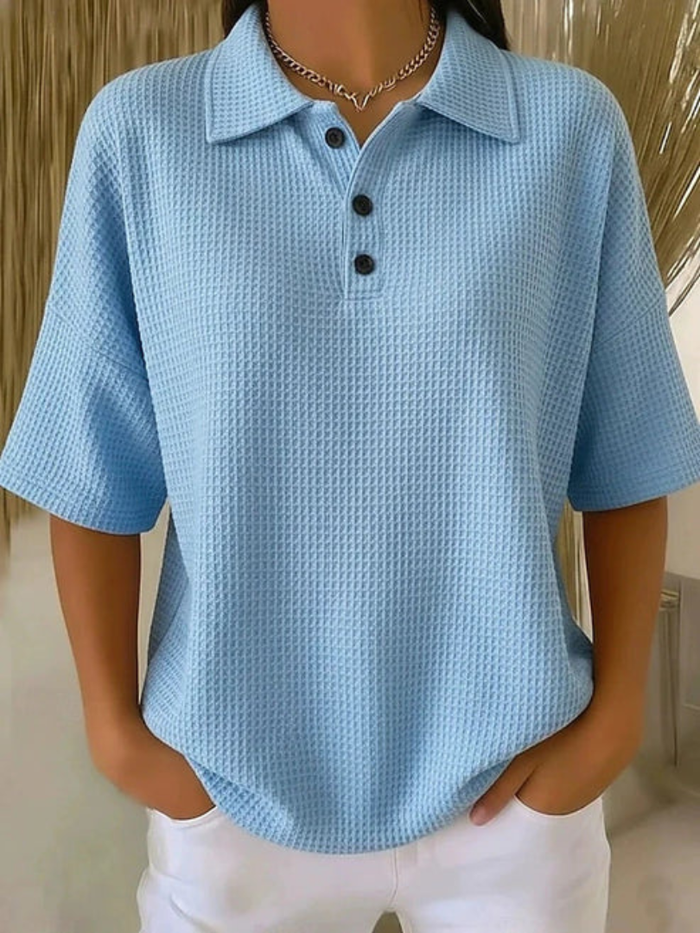 Peggie waffle polo blouse in light blue, front view with white trousers