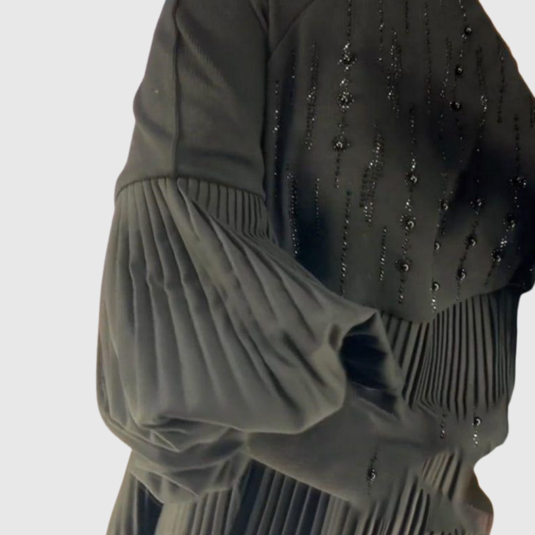 Close-up of beadwork and pleated puff sleeve on the black Elodie gown