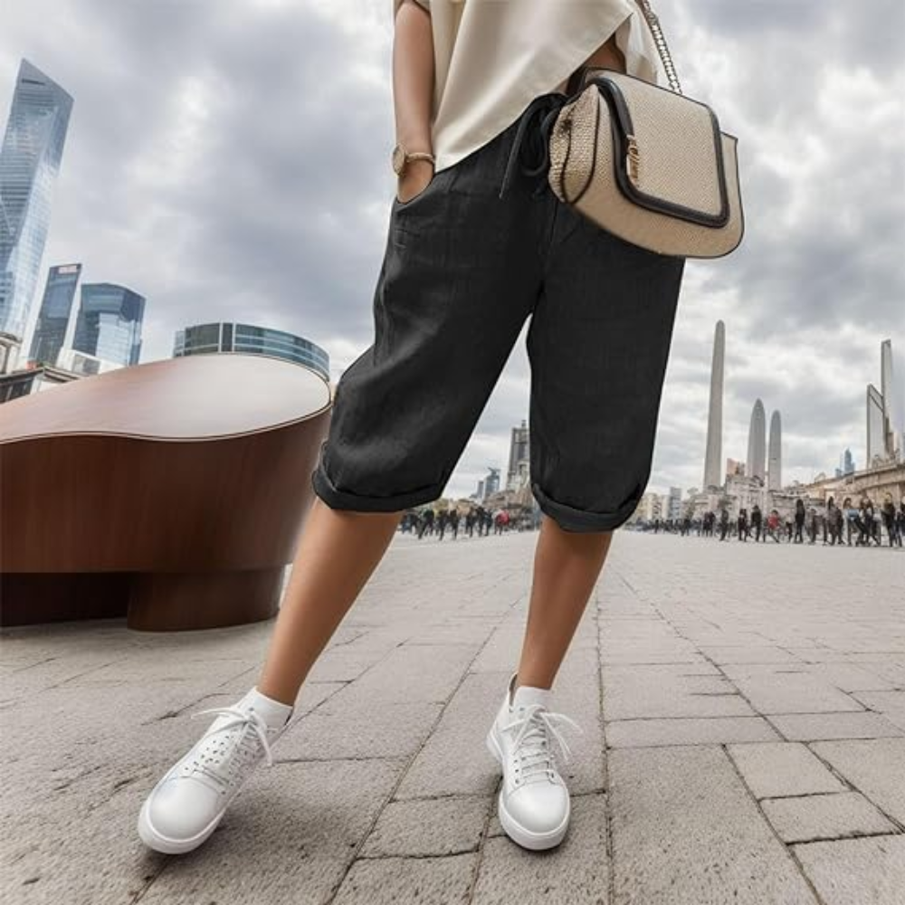 Noa cotton linen shorts in black, worn with white trainers