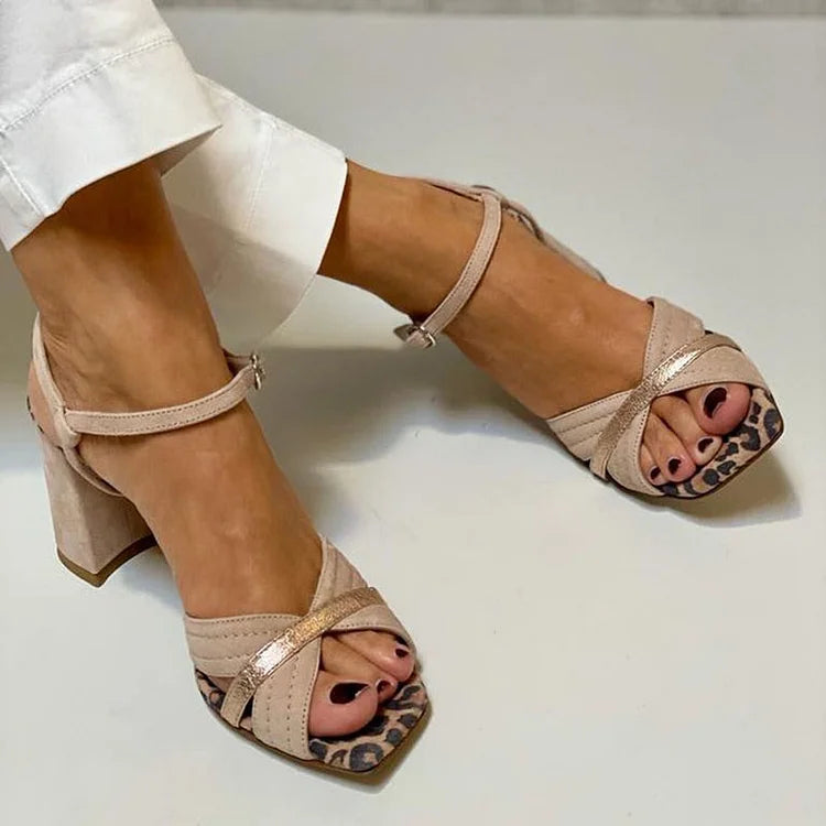 Khaki leopard print block heel sandals worn with white trousers, top view