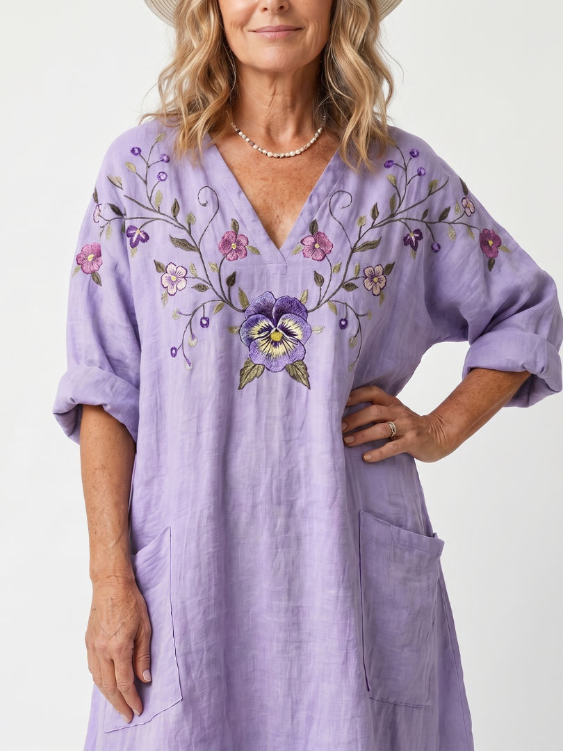 Close-up of pansy embroidery and V neckline on the Tavi lilac midi dress