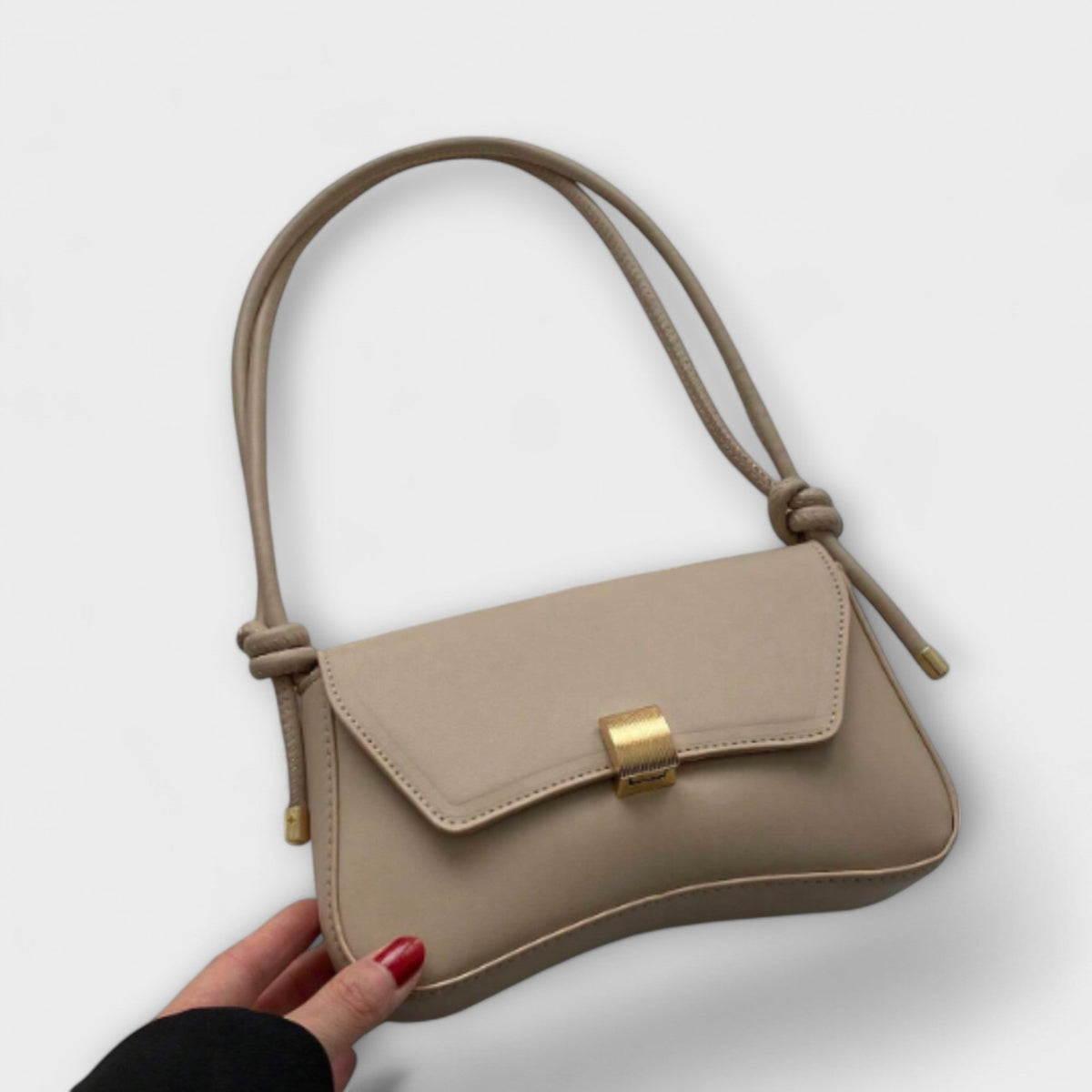 Cécile mini shoulder bag in beige, held front view