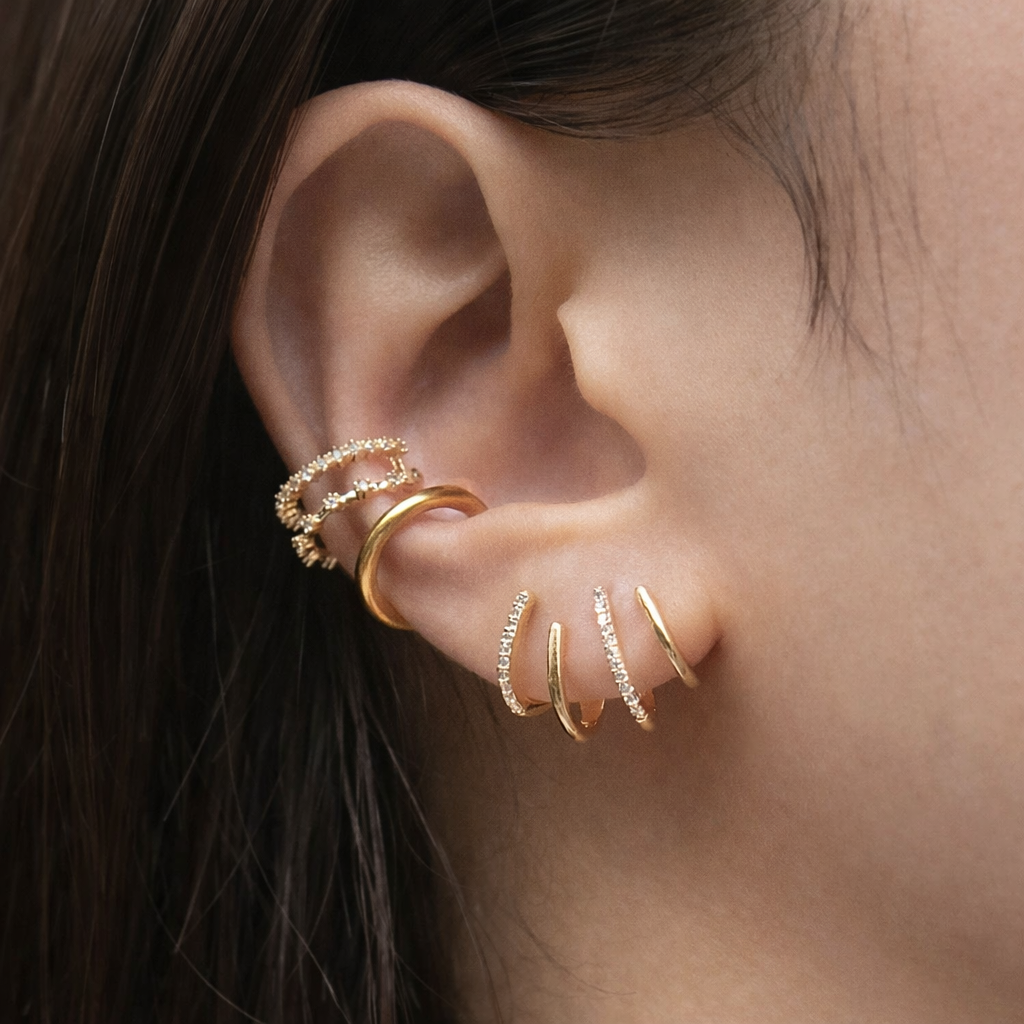 Zabby spiral ear cuff in gold worn on the ear, side view