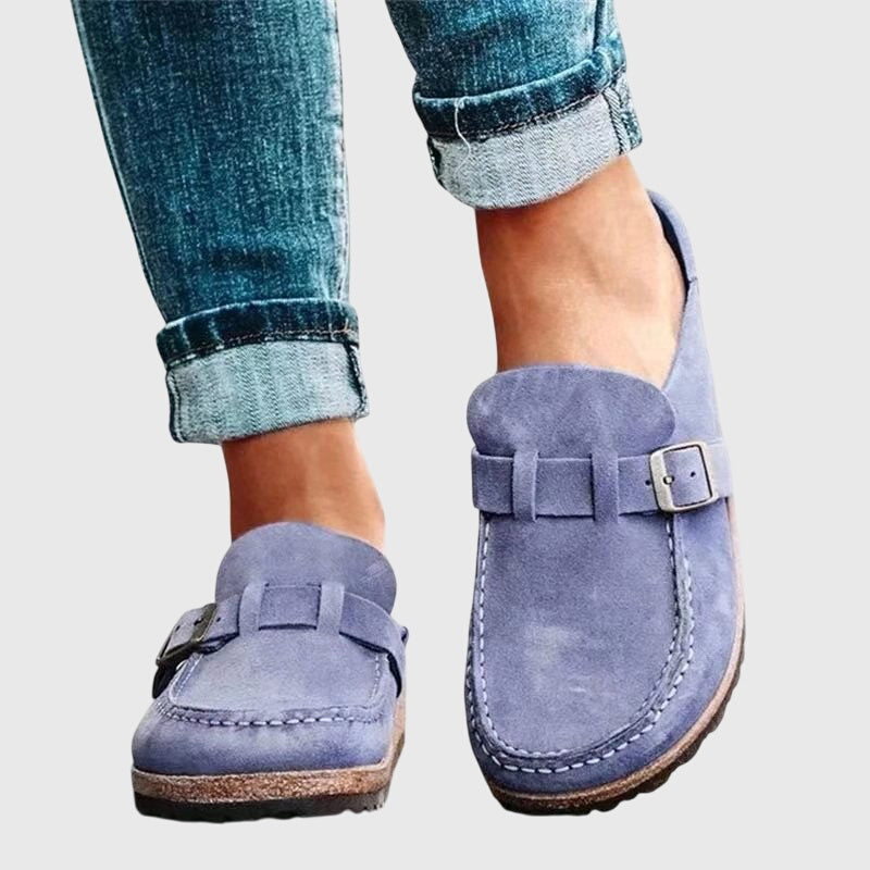 Kendra clogs in purple-blue worn with jeans, side view