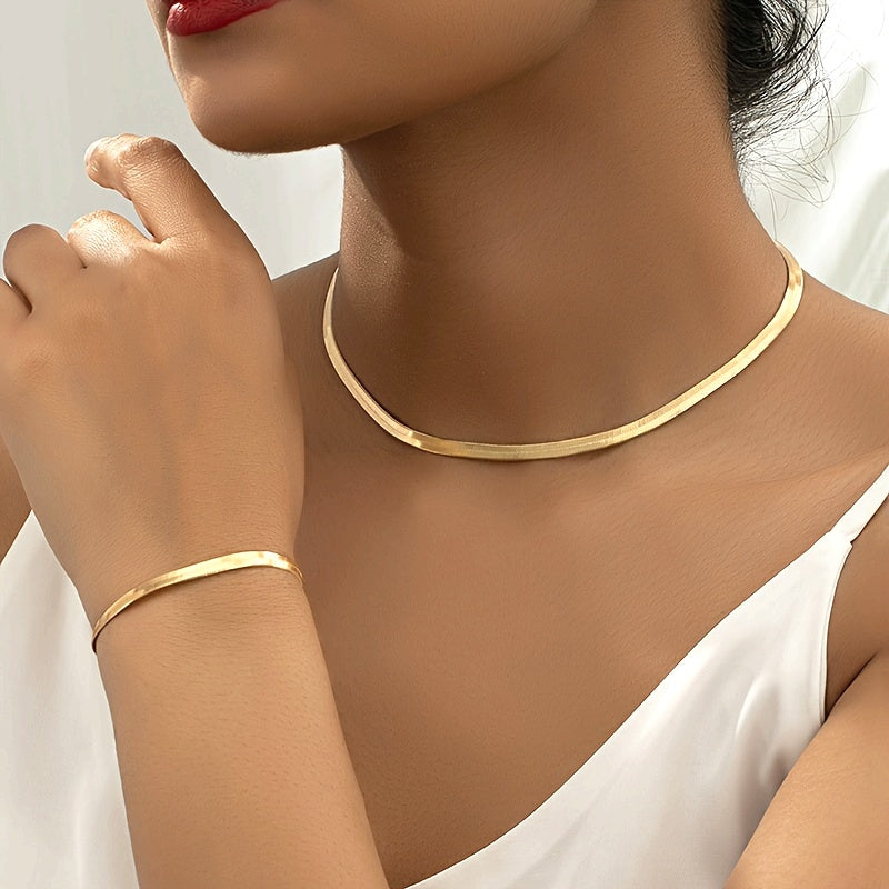 Vintage snake chain necklace and bracelet set in gold, worn close-up