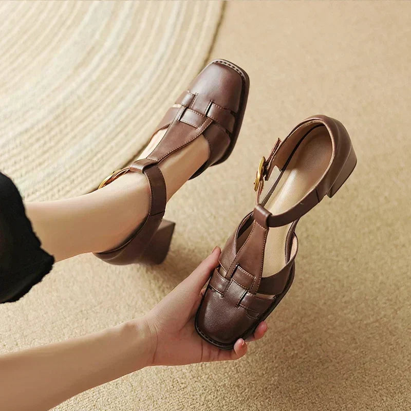 Belliora square toe sandals in brown, held close-up showing woven strap