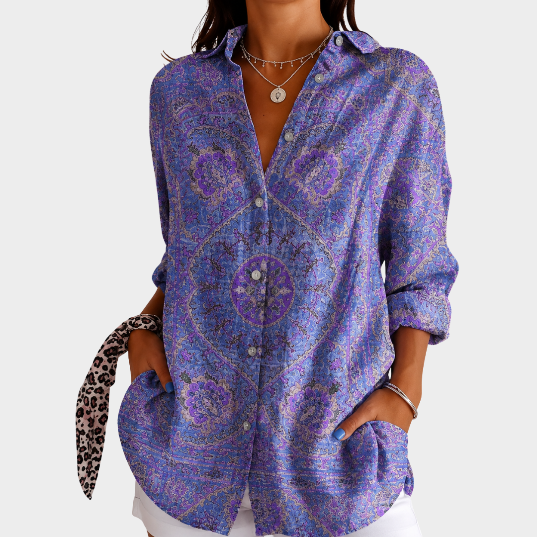 Summer colour print blouse in blue and purple, front view worn with white trousers