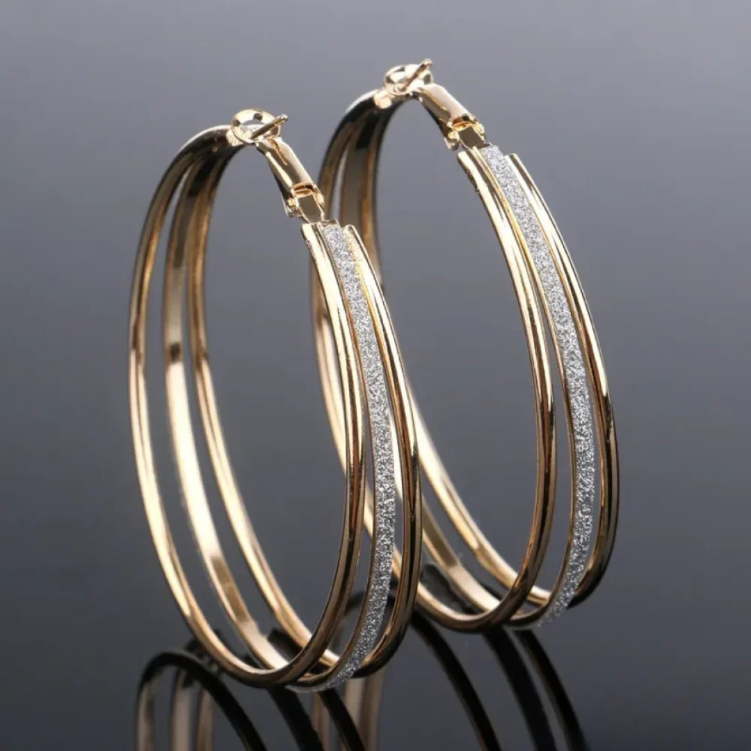 Retro gold hoop earrings with double bands and glittered centre stripe, side view