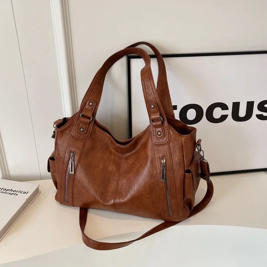 Casual shoulder bag in cognac, front view with zip pockets