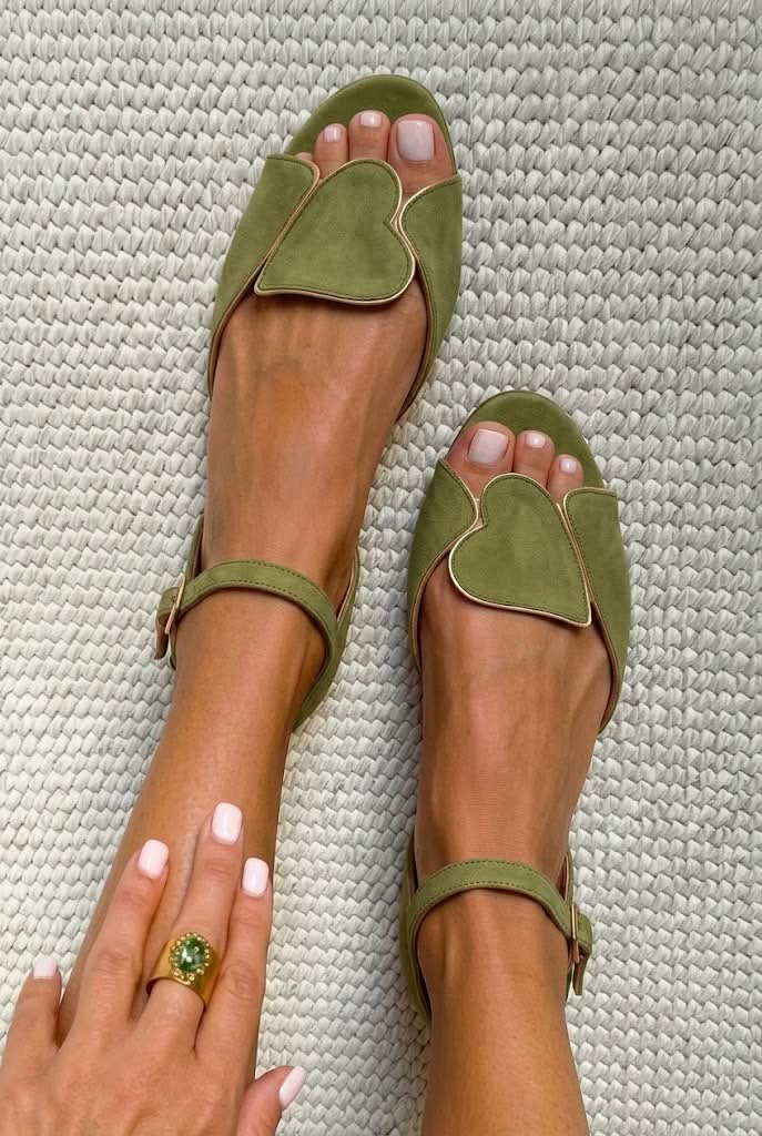 Olive open-toe sandals with gold-edged heart panel, worn top view