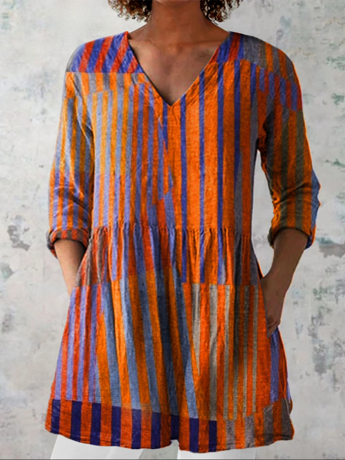Nadia long V-neck blouse in orange stripes, front view with pockets