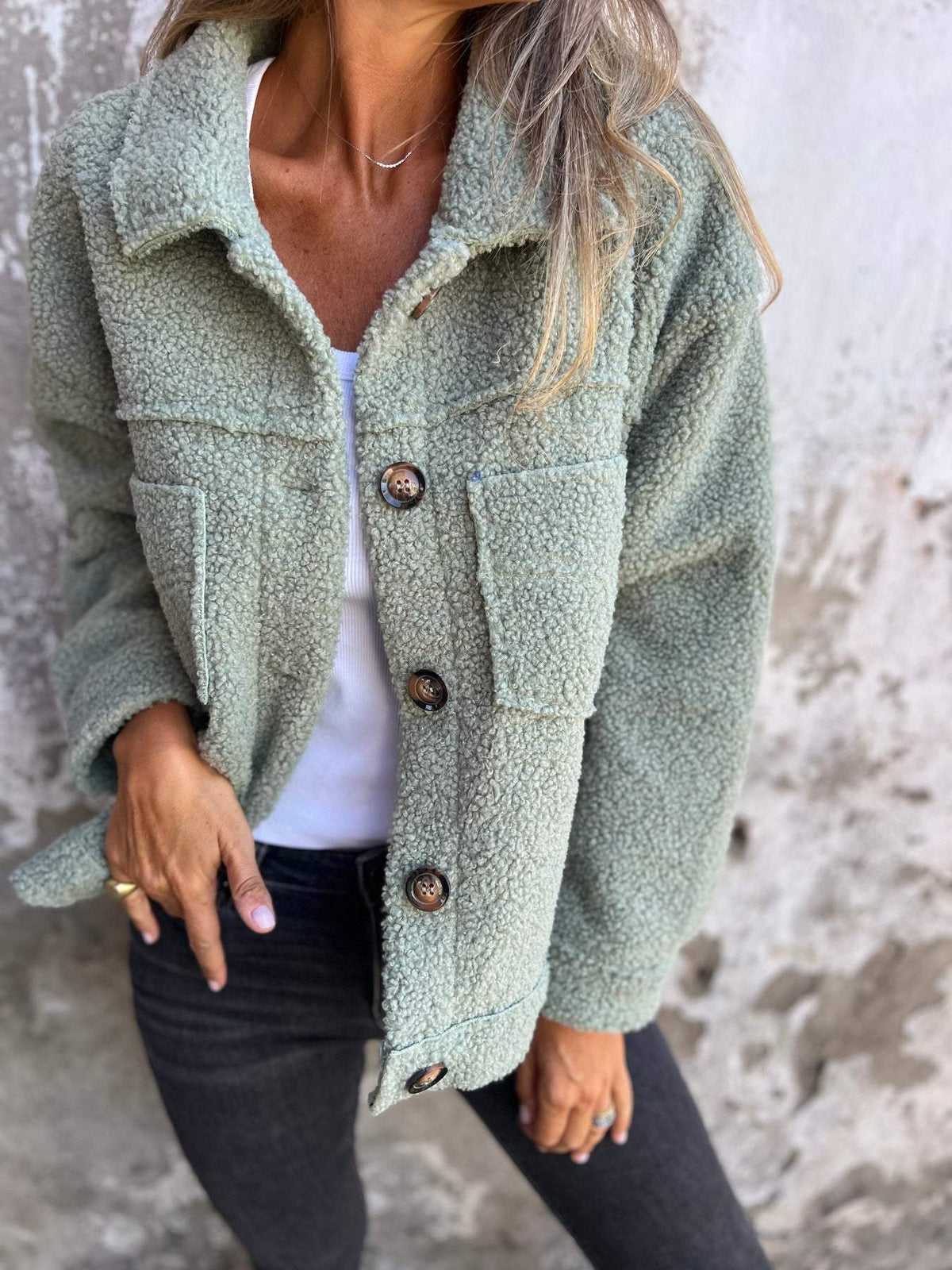 Laverinne cosy teddy jacket in green, worn with grey jeans