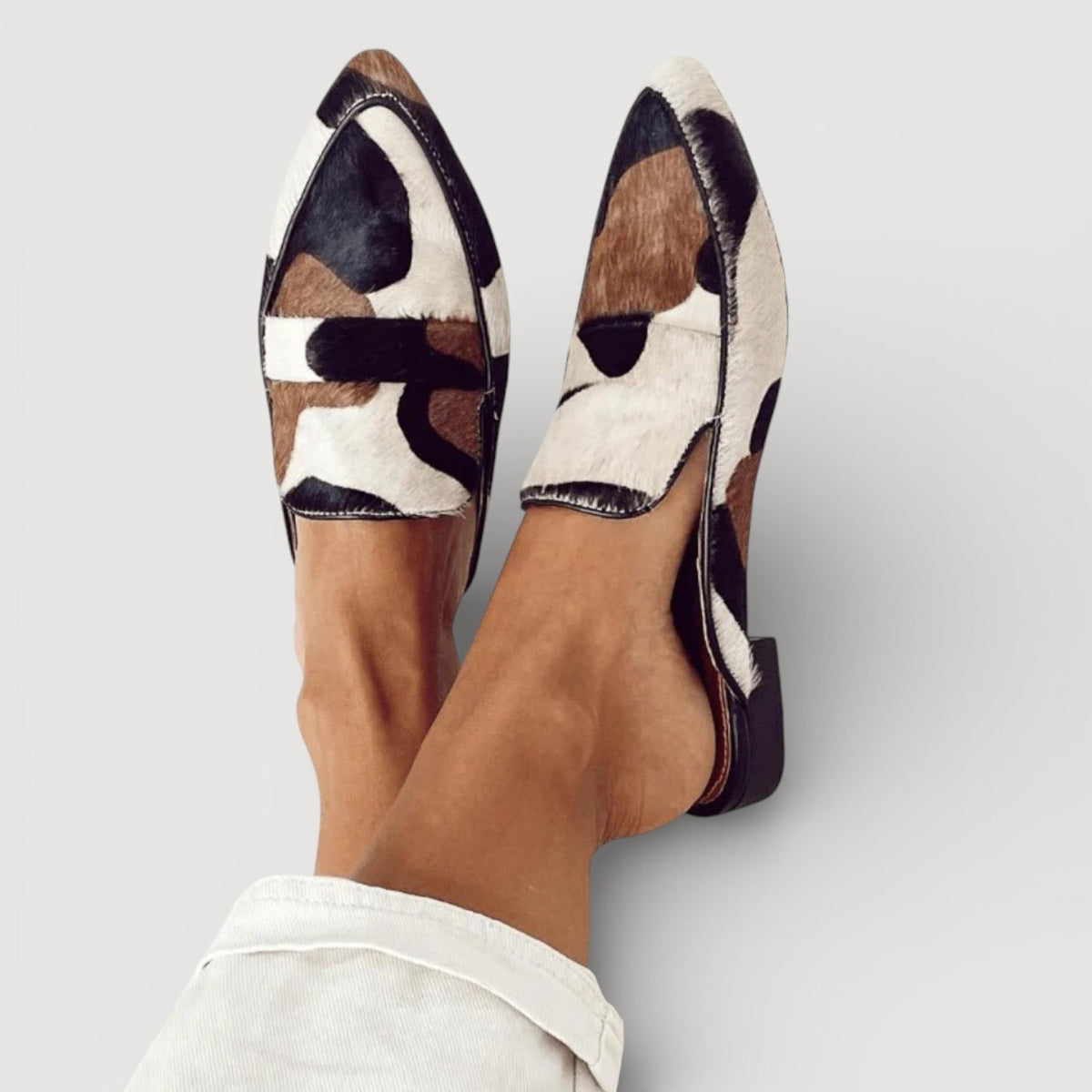 Cecilia minimalist loafers in black, brown and cream patchwork, worn top view