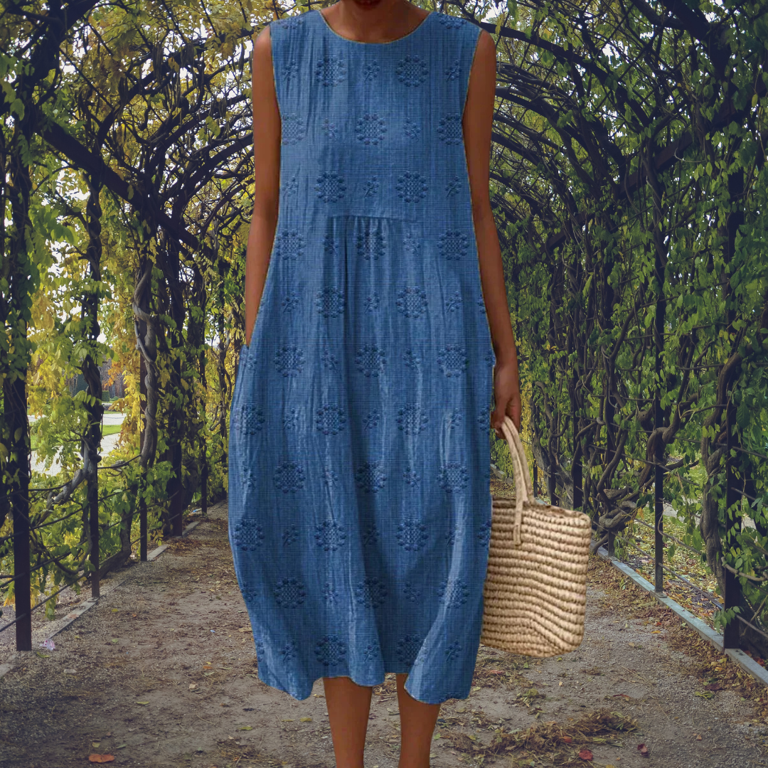Aikaterini sleeveless midi dress in blue, front view with basket bag