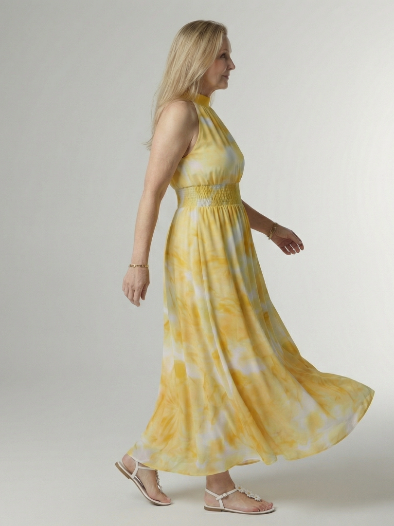 Sylin halter midi dress in yellow, side view showing flowing skirt