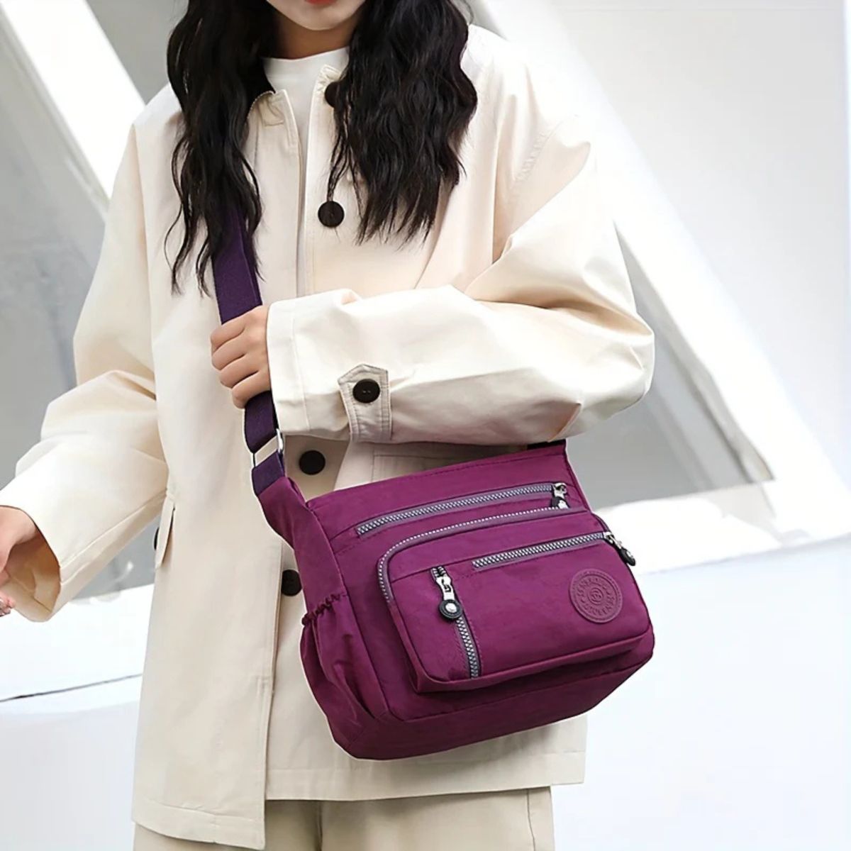 Evelisse shoulder bag in purple worn crossbody by a model