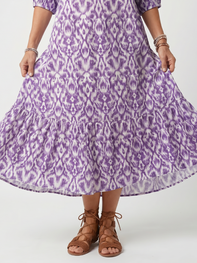Close-up of the purple ikat print and tiered flared hem