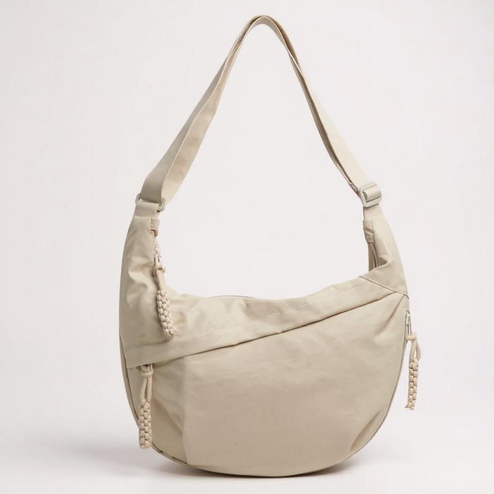 Arabella crescent shoulder bag in beige, front view with strap raised