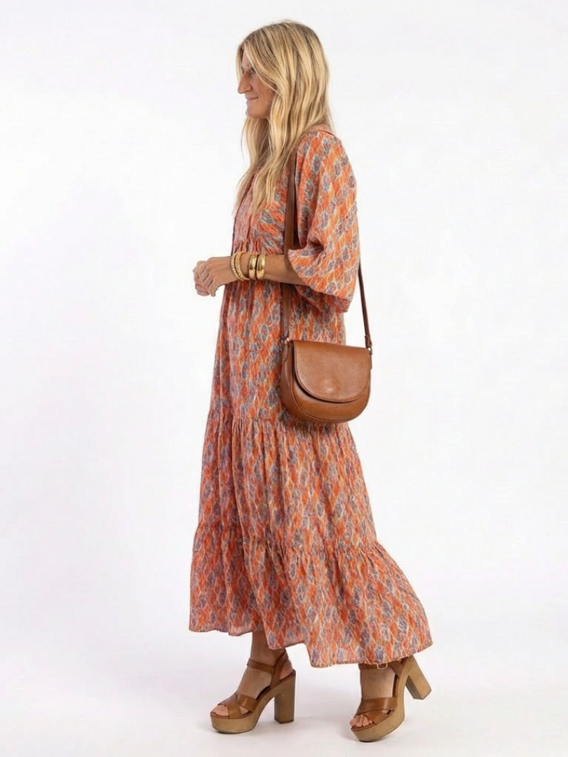 Amara tiered midi dress in coral print, side view showing flowing skirt