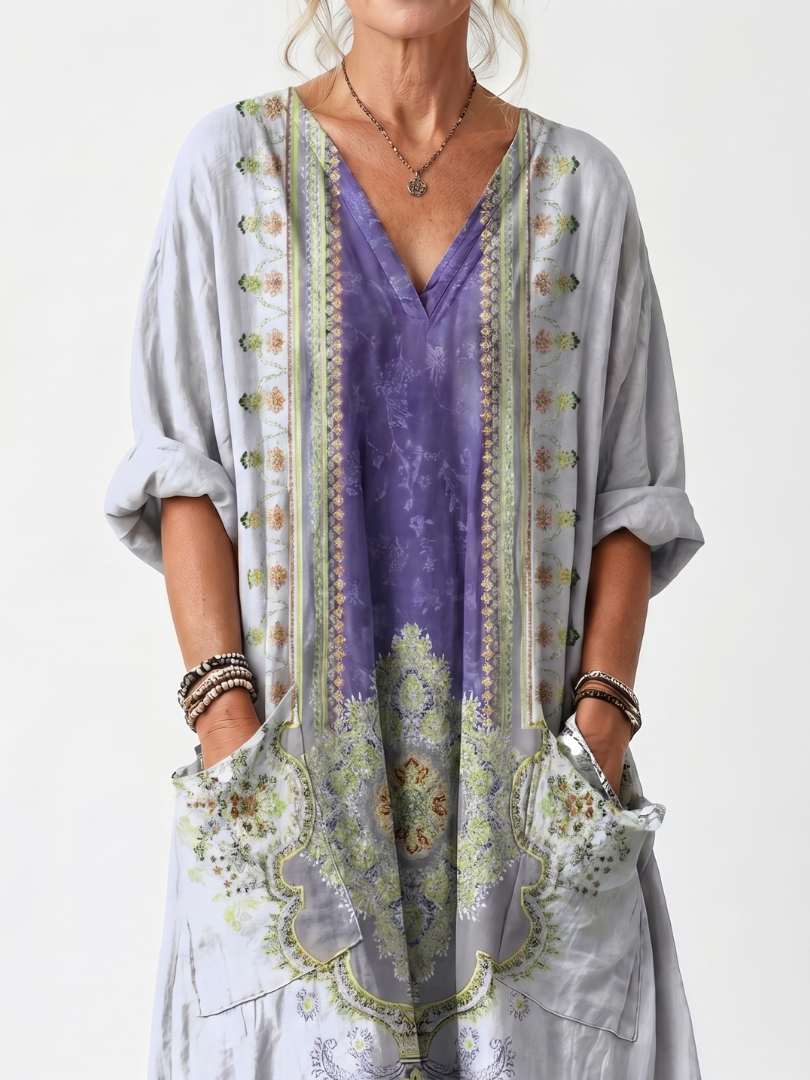 Close-up of Raina dress embroidered panel, V neckline and front pockets