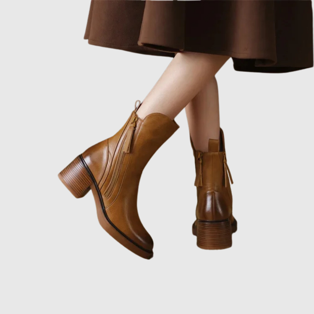 Streamlined ankle boots in brown worn with a brown skirt, front view