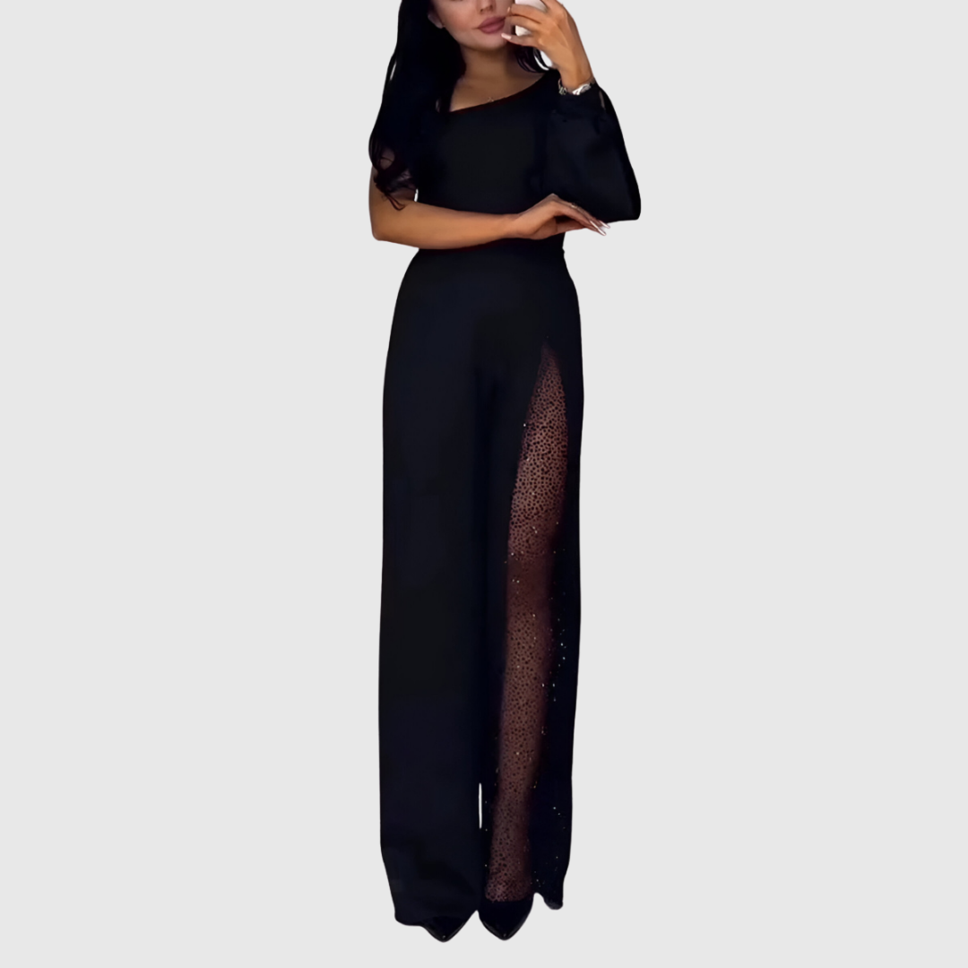 Eirisse wide-leg jumpsuit in black showing sheer glitter slit on the leg