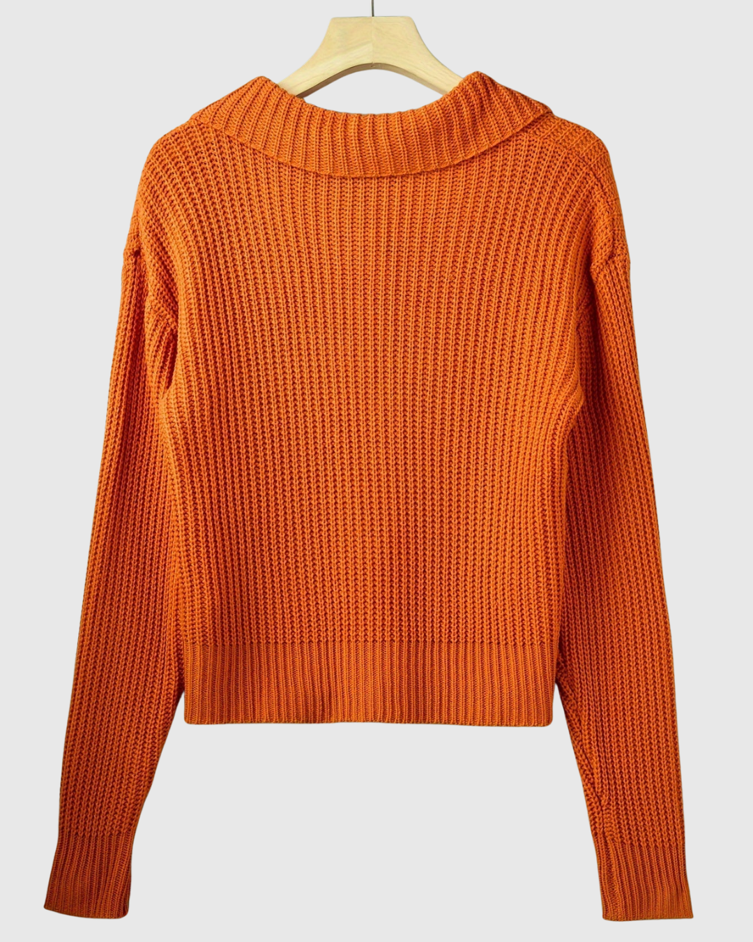 Marisse knit jacket in orange, back view on a hanger