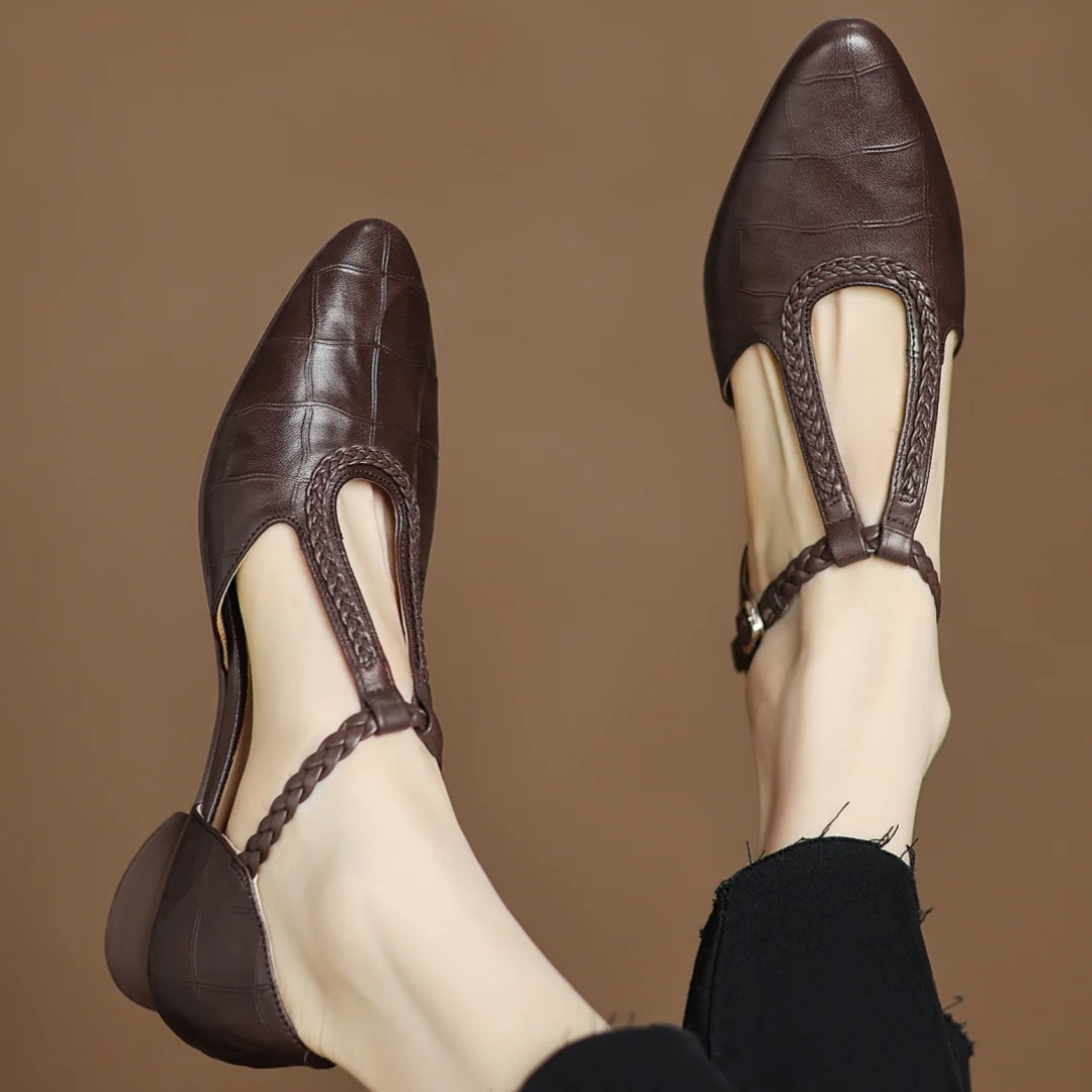 Evelyn Mary Jane shoes in brown, worn front view against warm backdrop