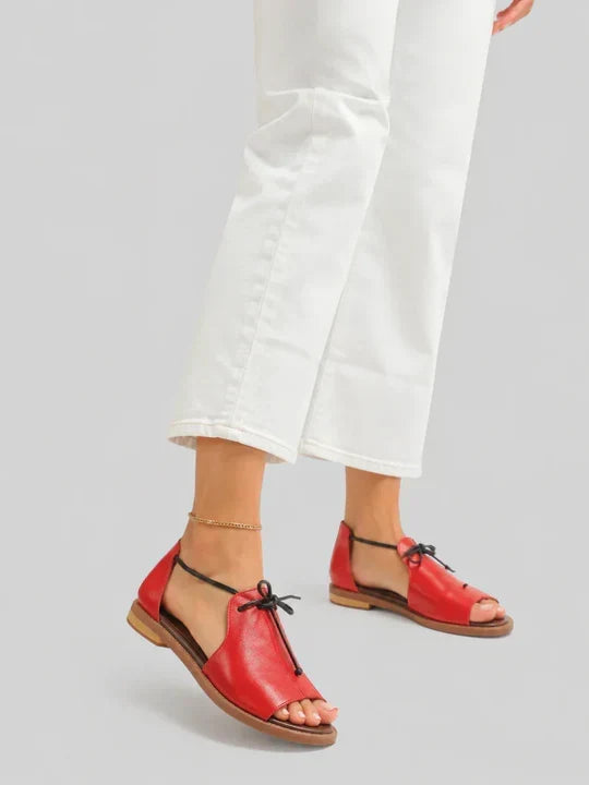 Lilliana leather sandals in red, worn with white cropped trousers