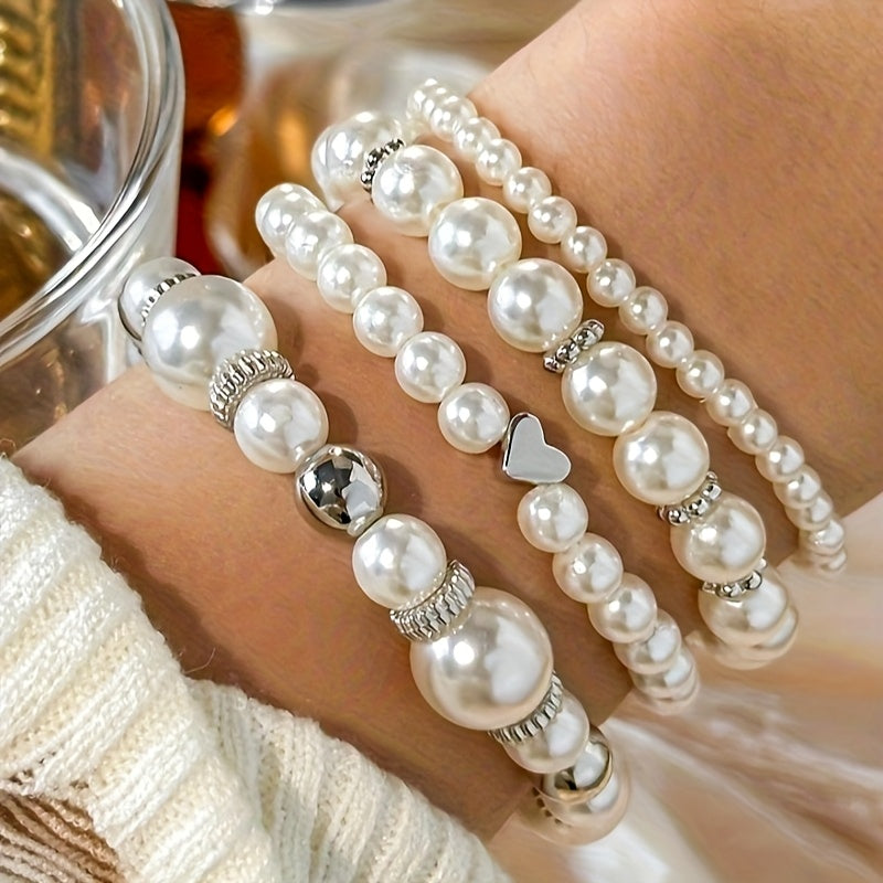 Pearl bracelet set in white with silver beads, worn stacked on wrist