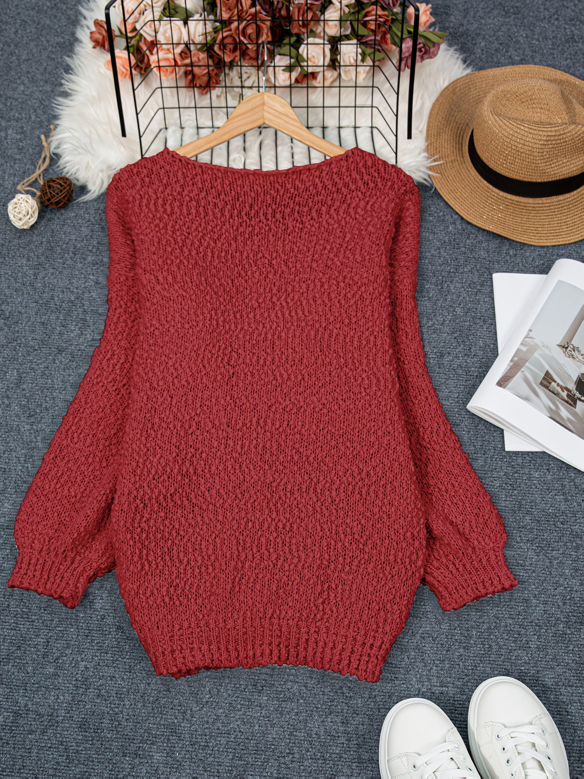Noraya round neck sweater in crimson, flat lay on hanger