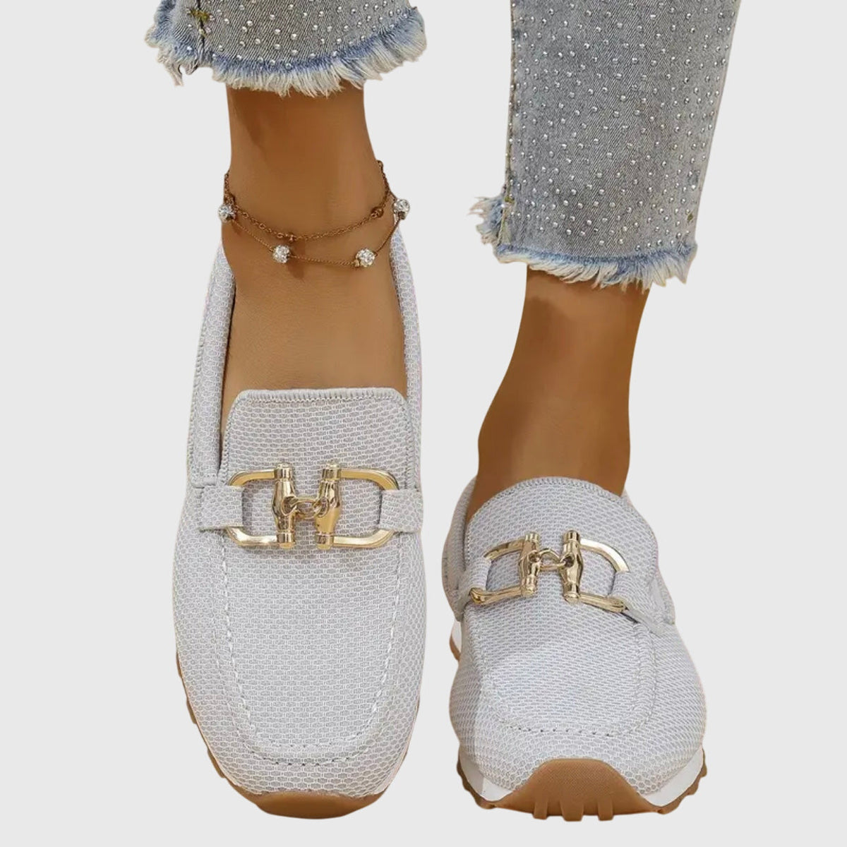 Shiloh loafer trainers in white with gold horsebit detail, worn front view