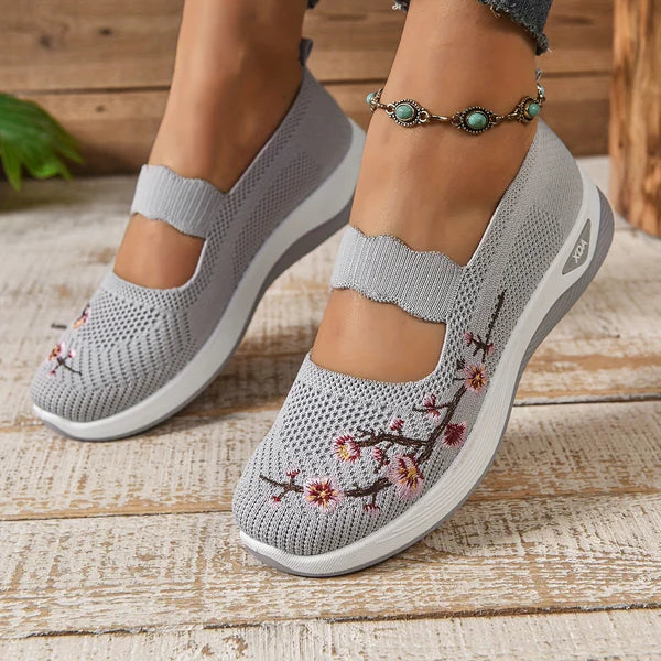 Leona slip-on orthopaedic shoes in grey with floral embroidery, worn angled view