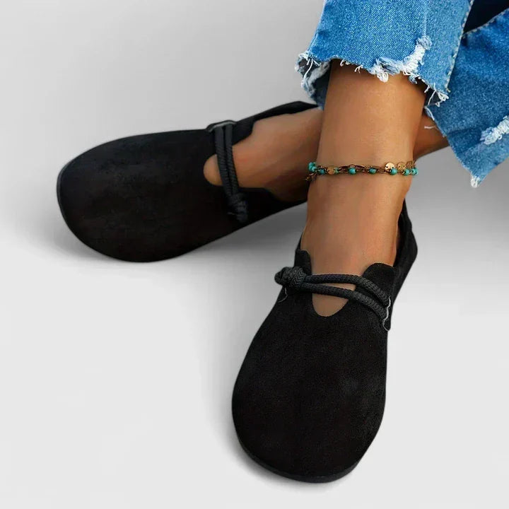 Edith loafers in black, worn angled view with cropped jeans