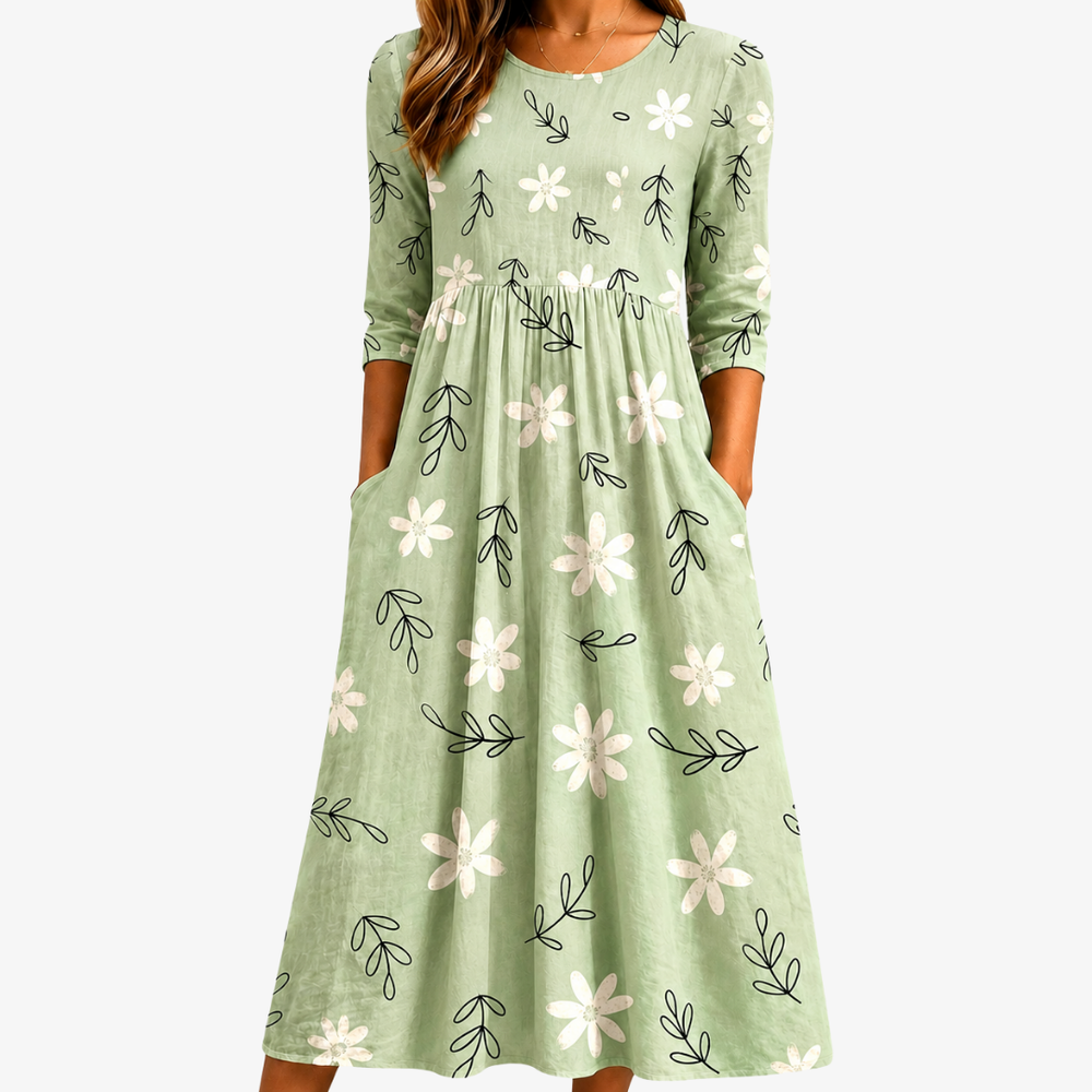 Sage blossom pocket midi dress in sage green, front view with hands in pockets