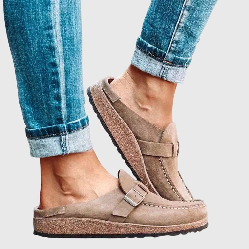 Kendra clogs in beige, close-up of open back and buckle strap
