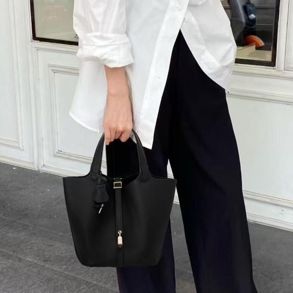 Kate lock bag in black, styled with white shirt and wide trousers