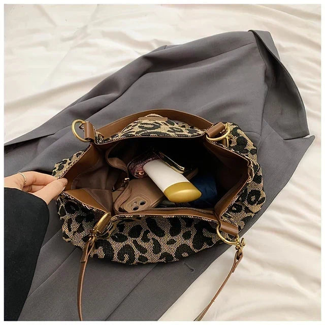 Tavira leopard tote bag open, showing spacious interior with phone and essentials